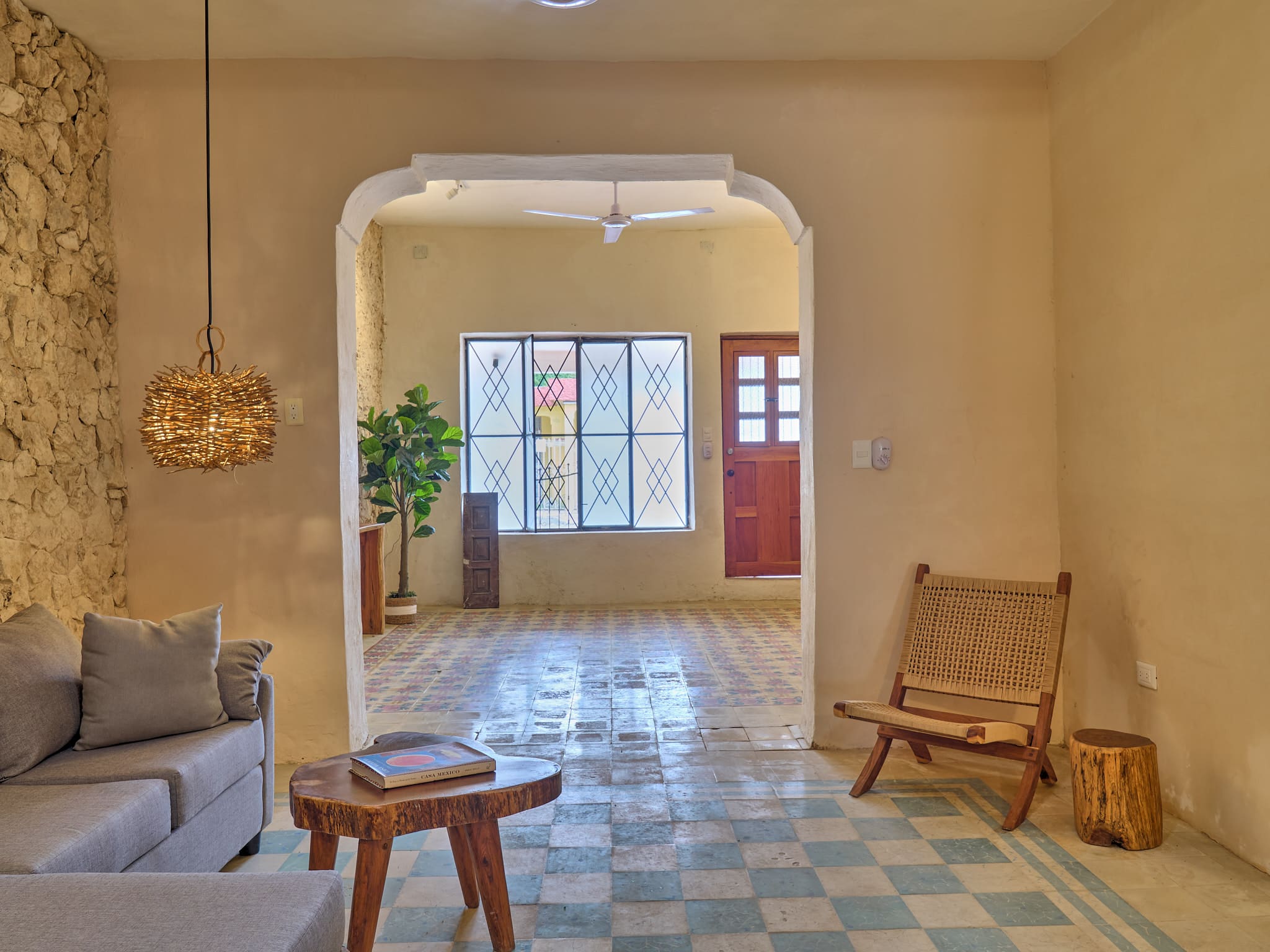 Cozy, sunlit room with vintage decor and patterned floor tiles.