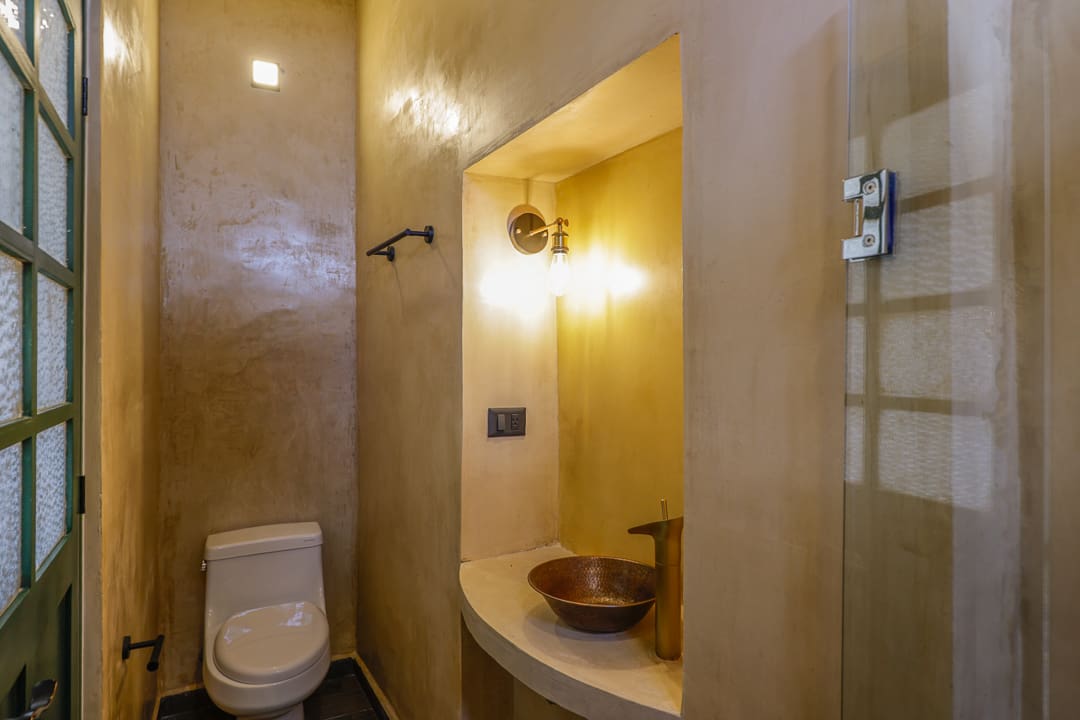 Warm-toned bathroom with rustic decor and soft lighting.