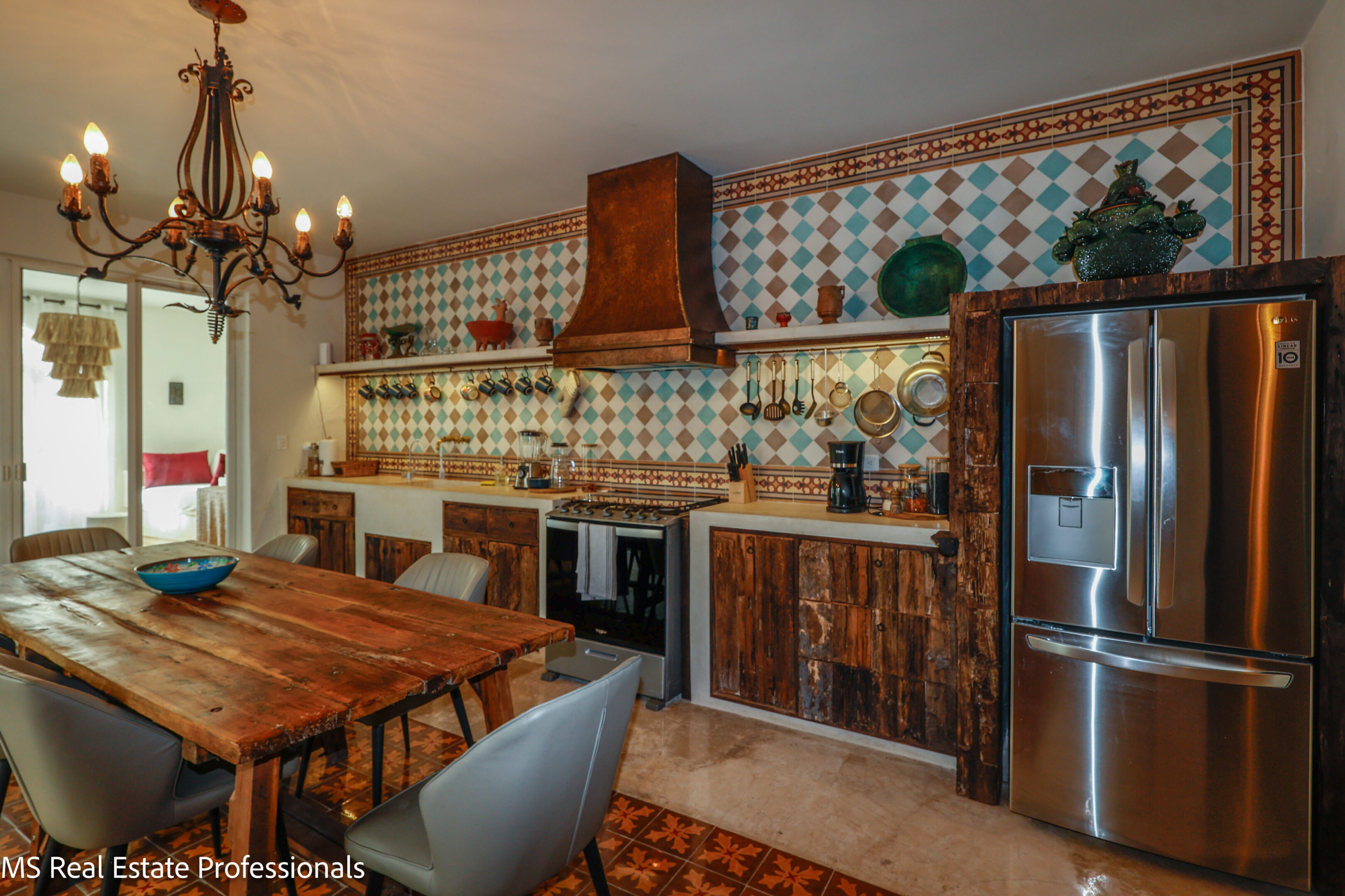 Rustic kitchen with wooden cabinetry and tiled backsplash.