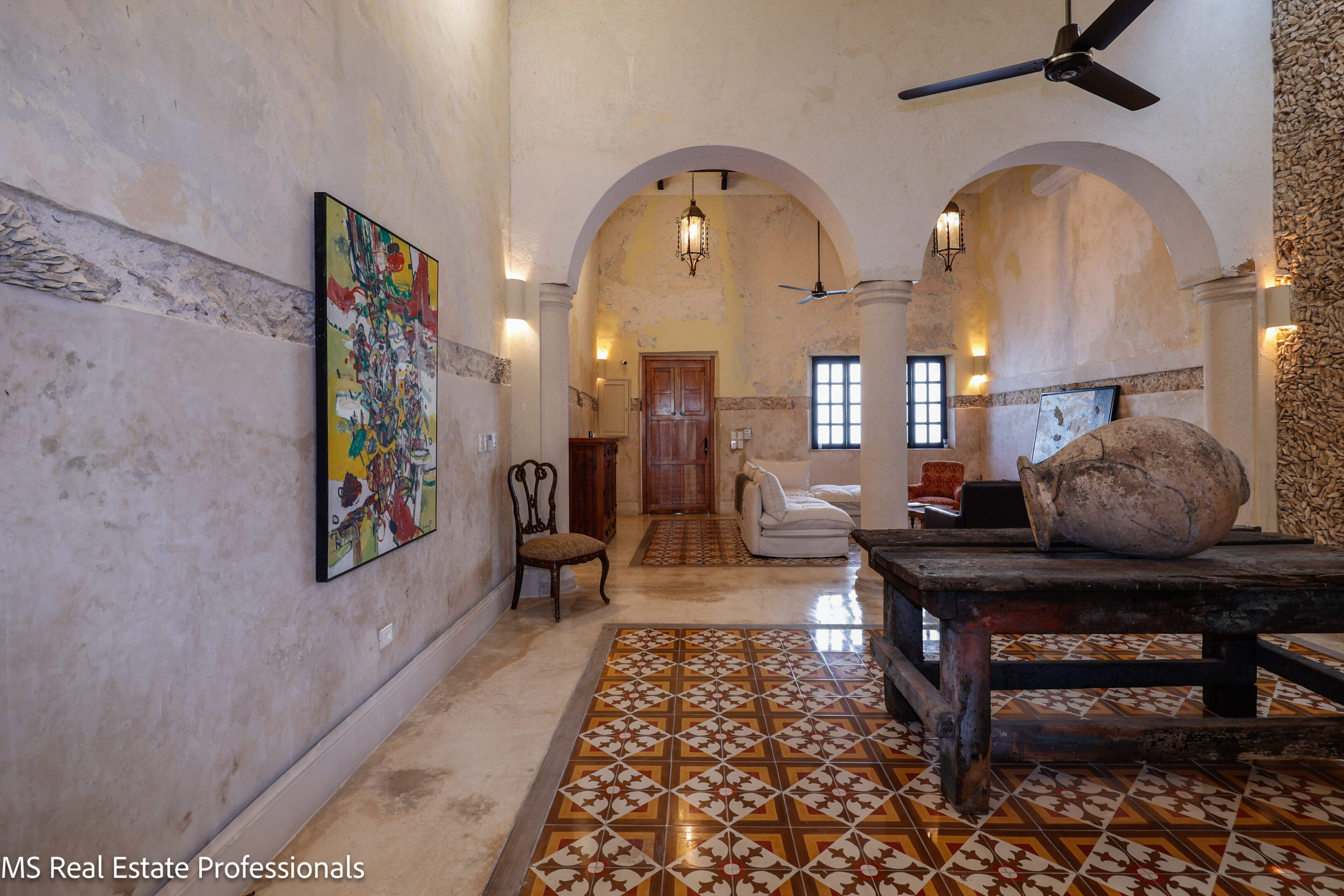 Elegant living room with vintage tiles and arched doorways.