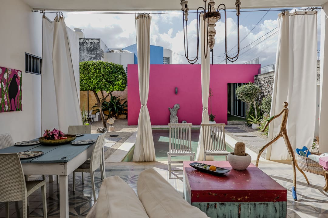 Chic rooftop lounge with large pink LOVE letters and cozy seating.