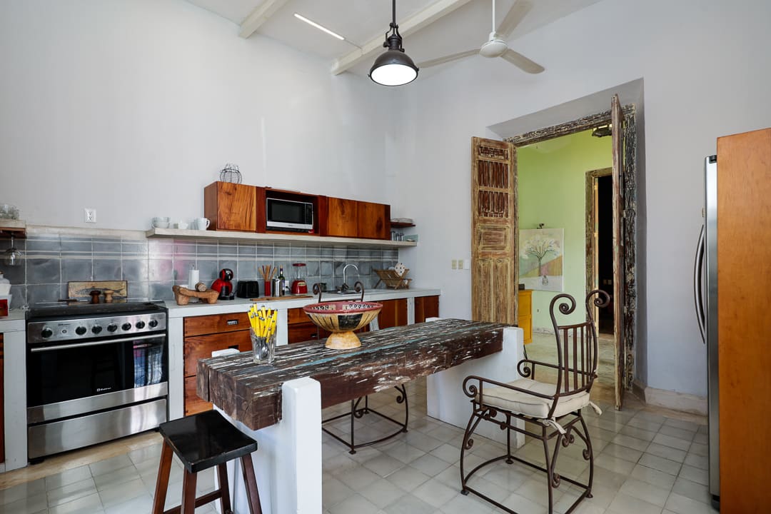 Cozy kitchen with rustic wooden furniture and modern appliances.