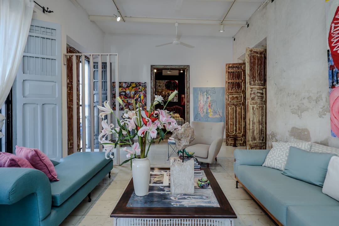 Cozy living room with blue sofas and floral centerpiece.