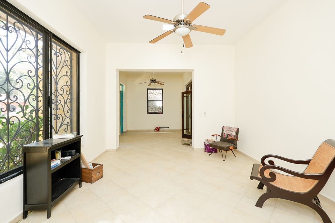 Bright, spacious room with ceiling fan and classic decor.
