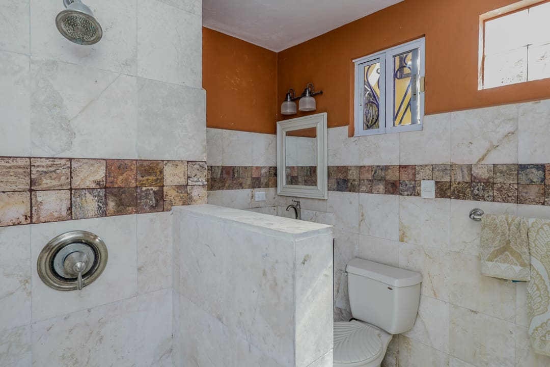 Modern bathroom with marble and earthy tones.