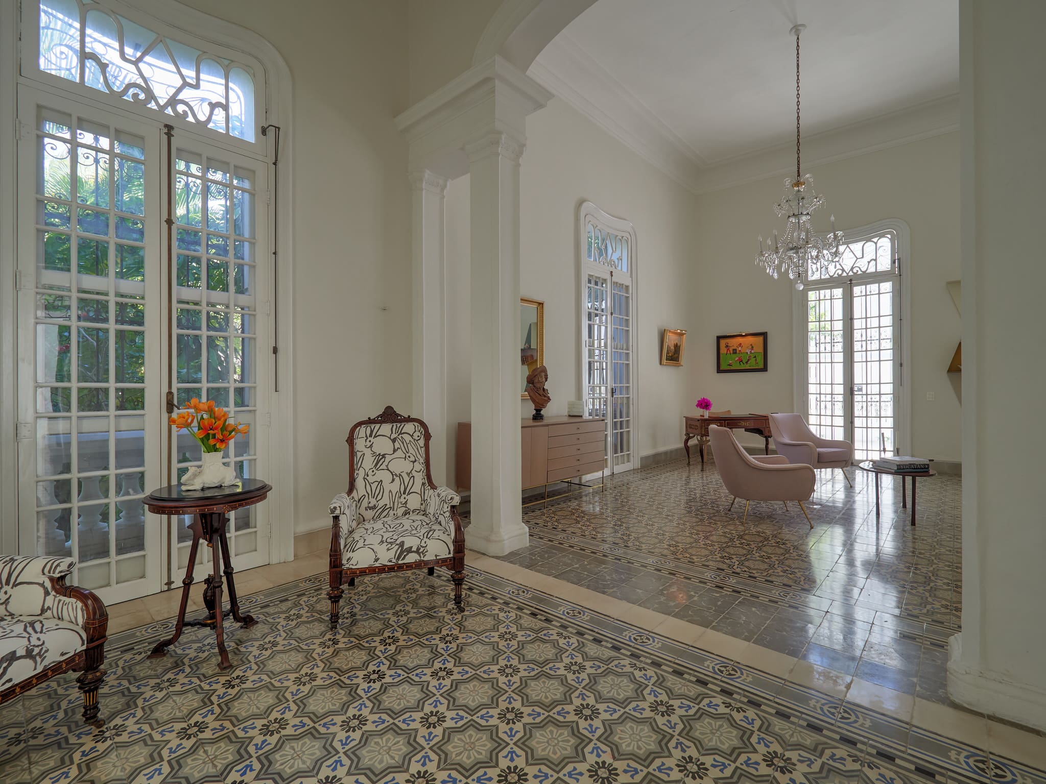 Elegant vintage living room with patterned tile floors and classic furniture.