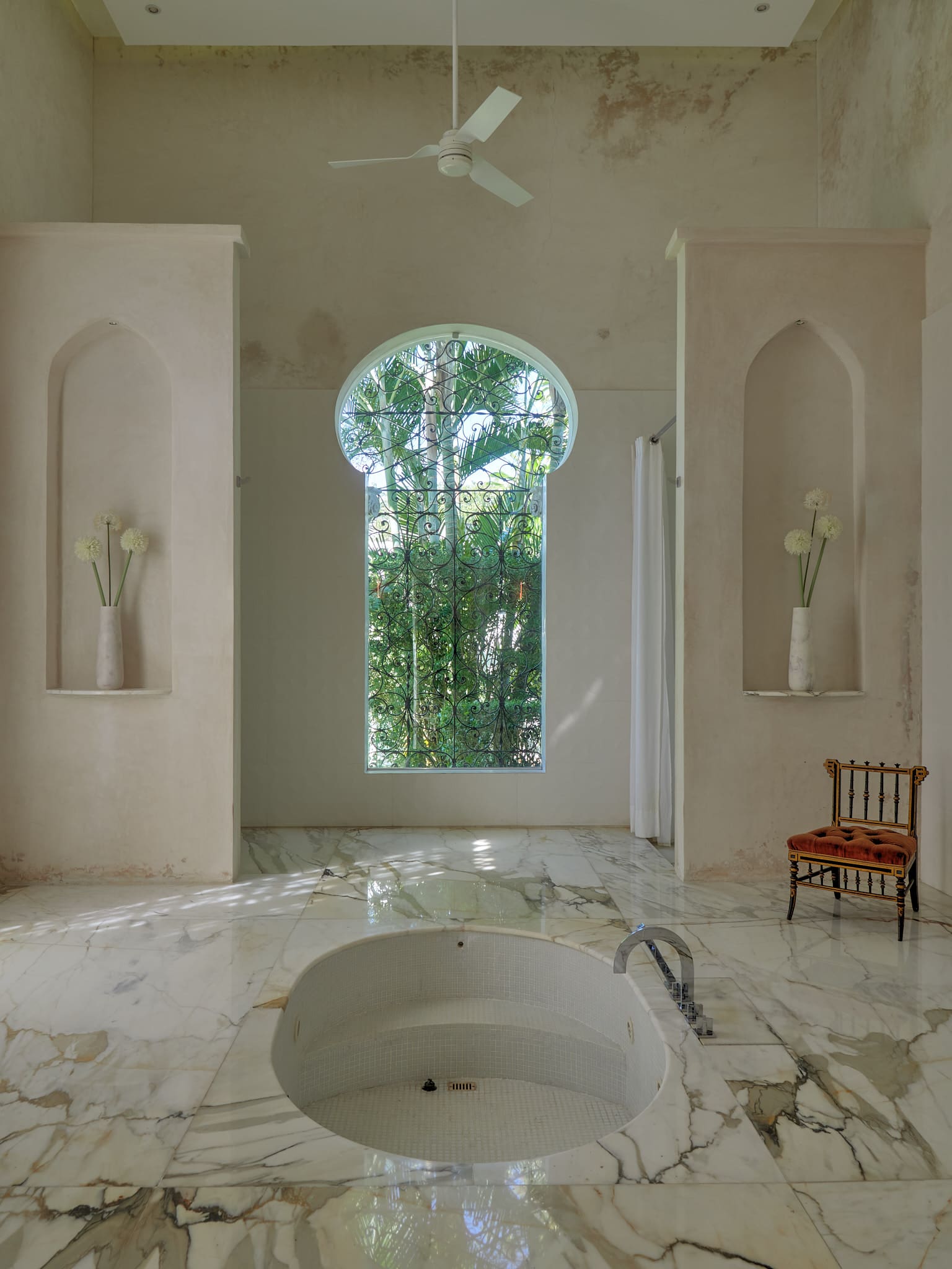 Elegant bathroom with a nature-view window and vintage decor.