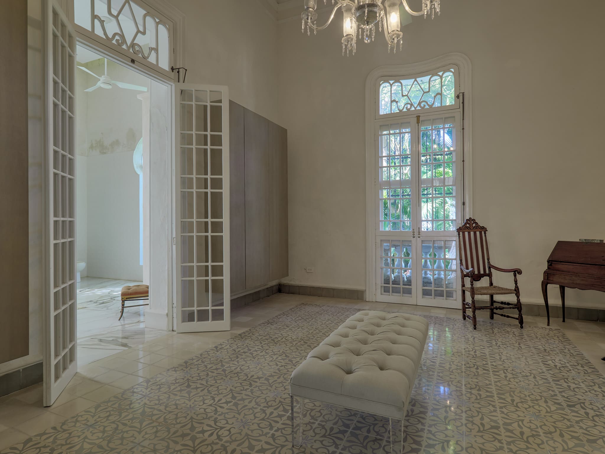 Bright, serene room with classic furniture and large windows.