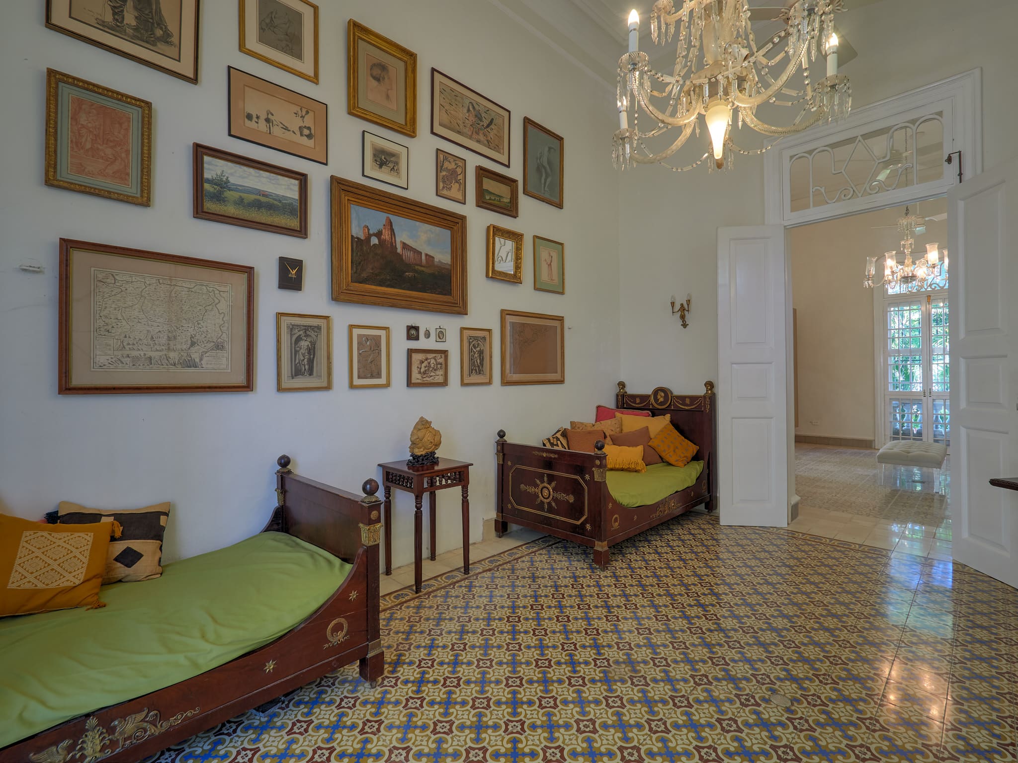 Elegant vintage room with framed art and patterned tiled floor.