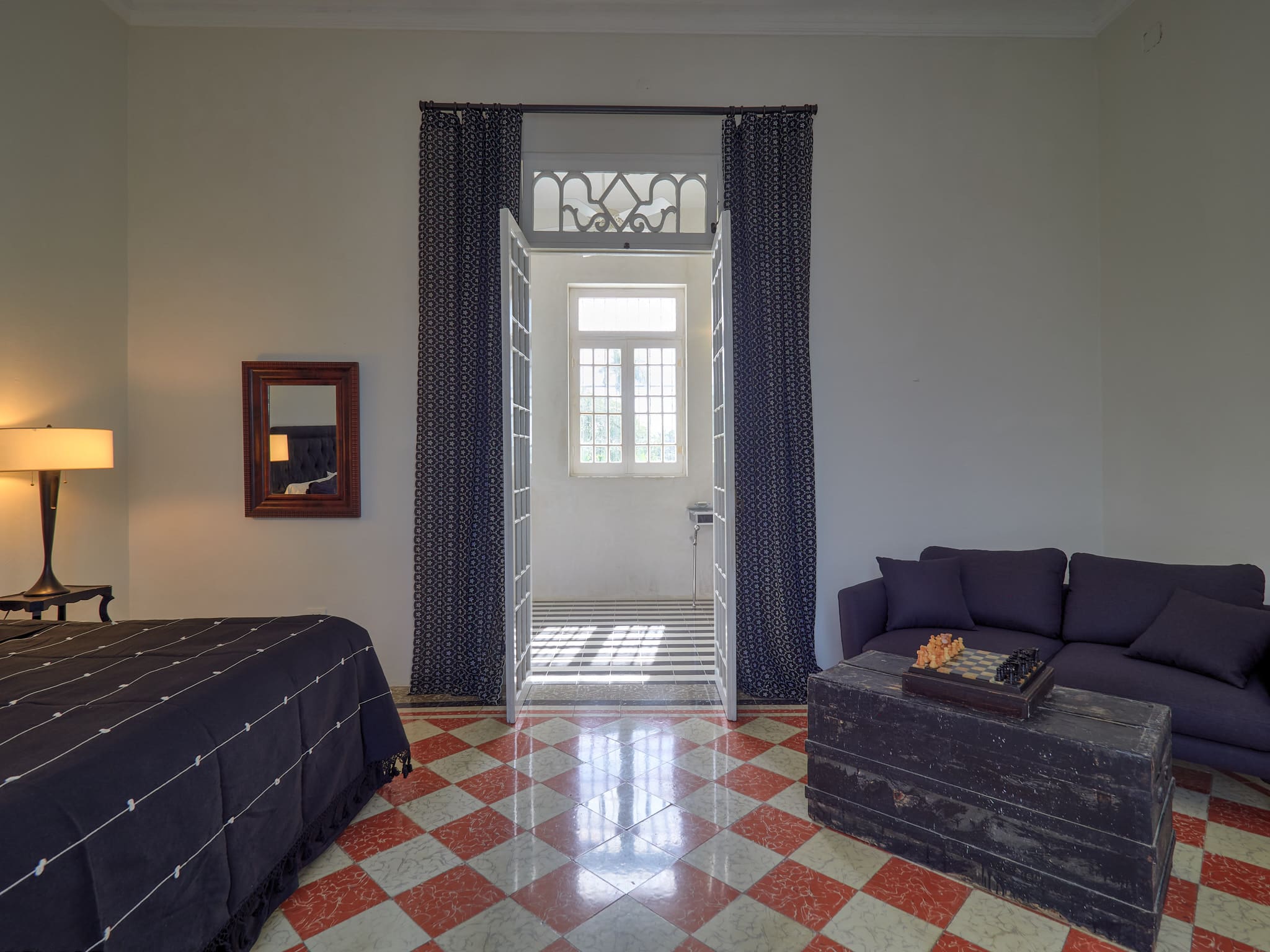 Elegant room with marble floor and large window letting in natural light.