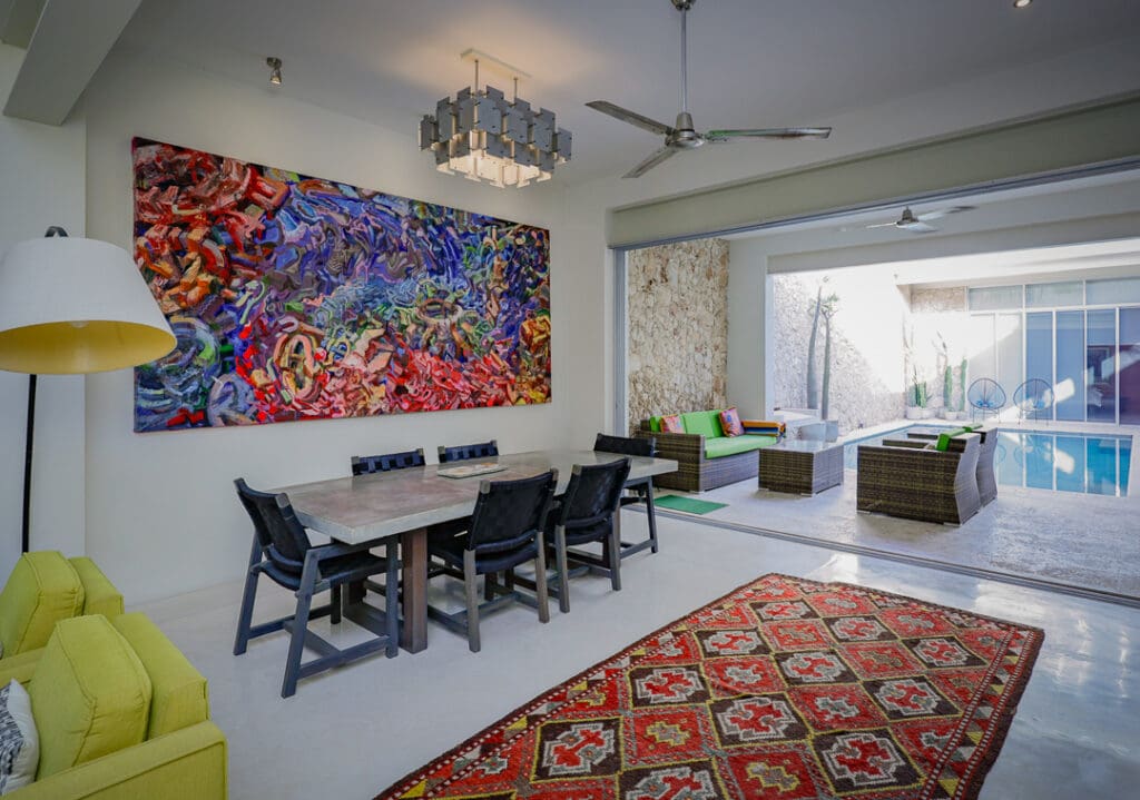 Modern dining area with colorful artwork and cozy living space.