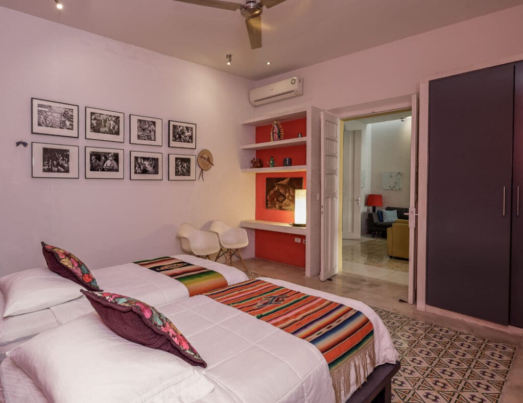 Cozy bedroom with warm lighting and colorful decor.