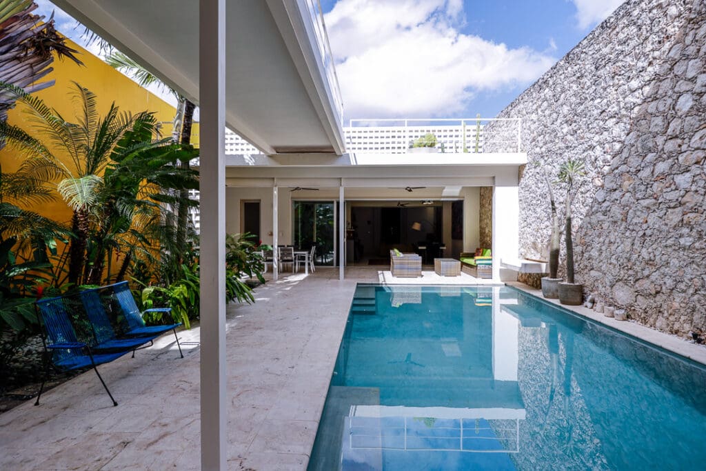 Modern courtyard with a clear swimming pool and lounge area.