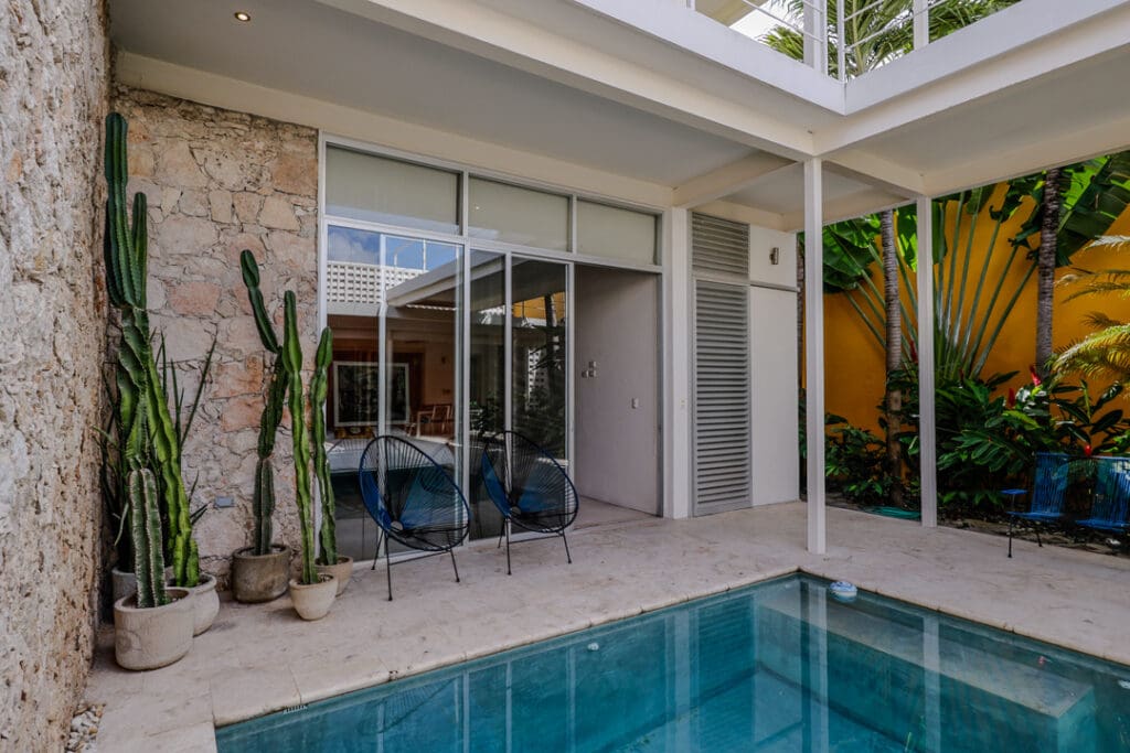 Modern patio with pool and outdoor seating area.