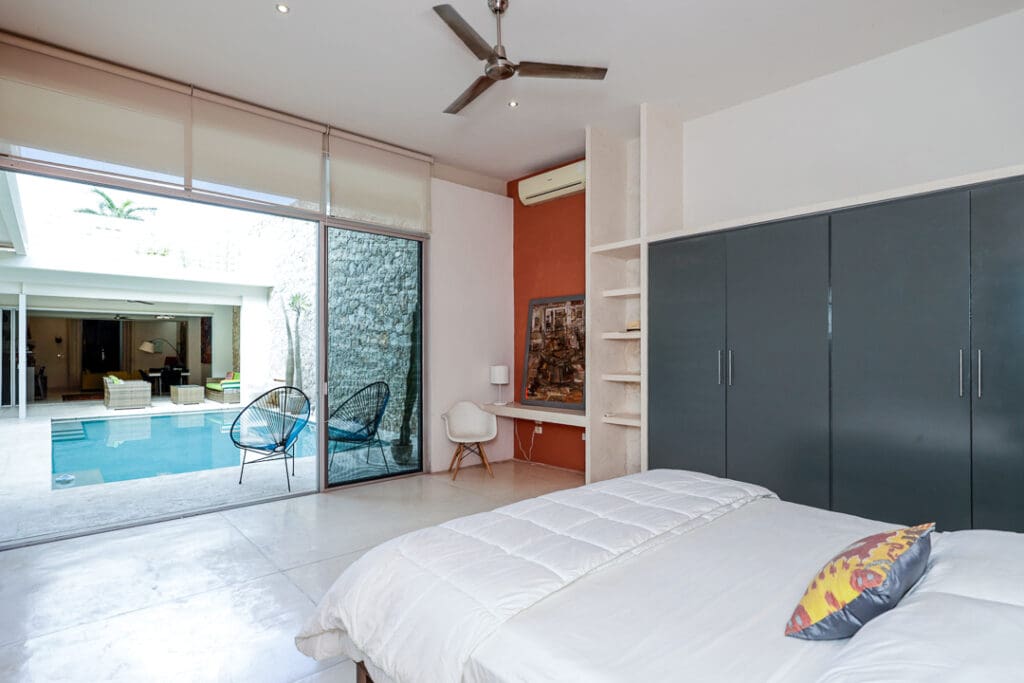 Bright bedroom with modern decor and large sliding glass doors.