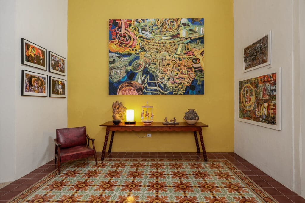 A cozy room with a colorful wall tapestry and vintage decor.