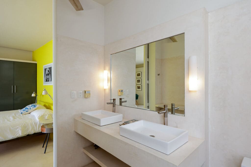 Modern bathroom with double sinks and large mirror.