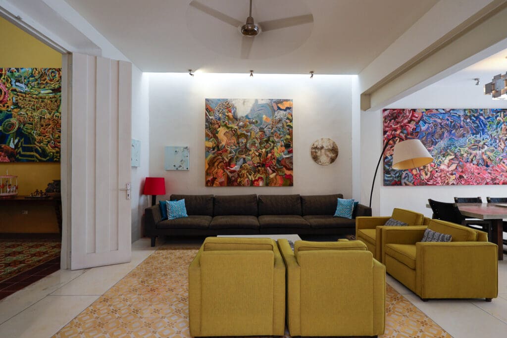 Modern living room with colorful abstract art and cozy seating.