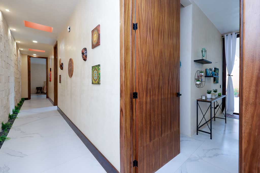 Modern hallway with wooden doors and minimalistic decor.