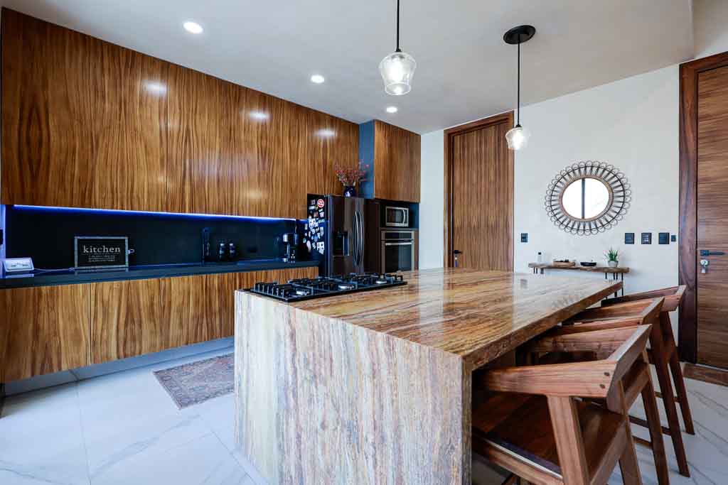 Modern kitchen with wooden cabinets and a large island.