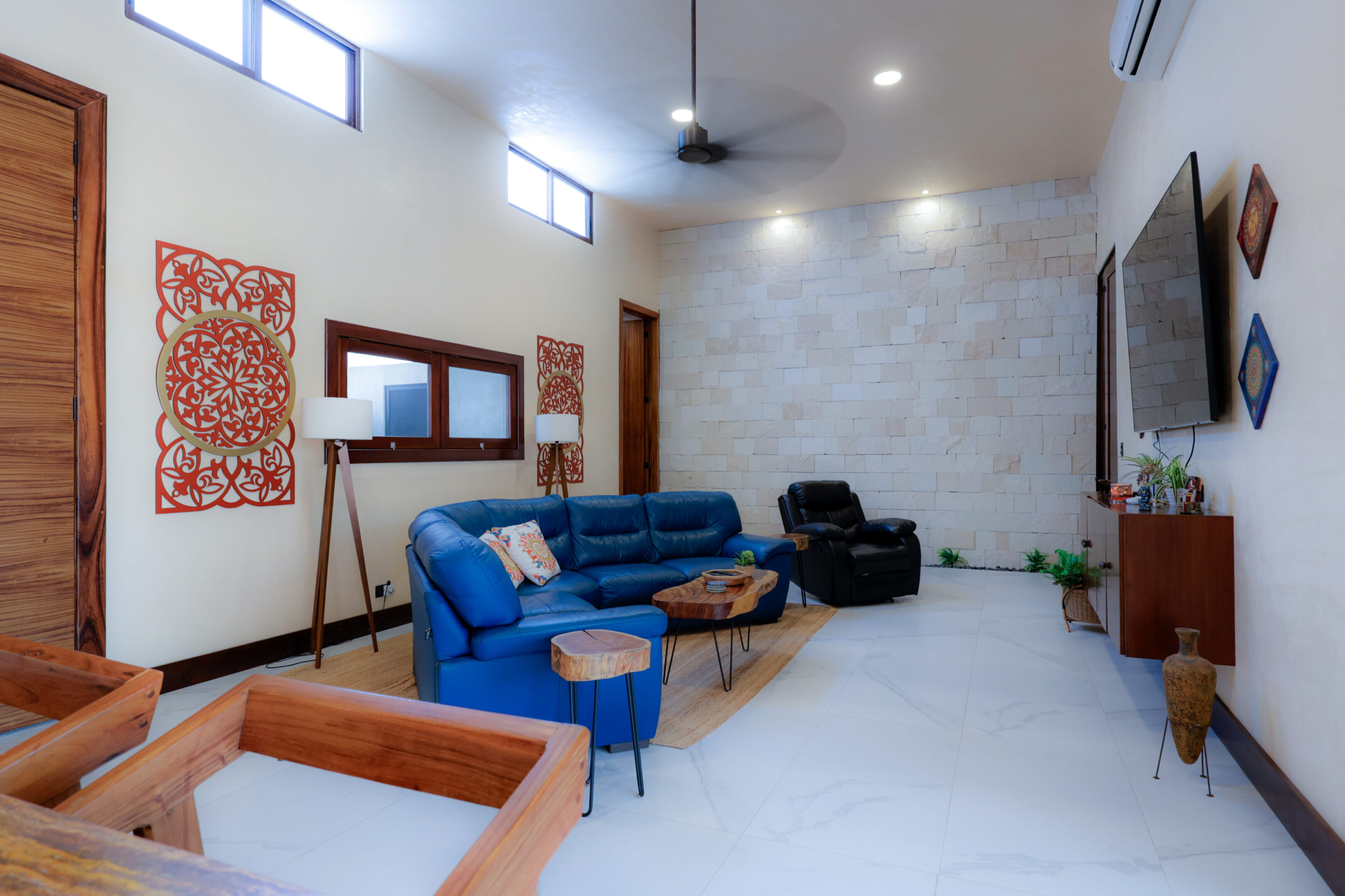 Modern living room with blue sofa and minimalist decor.