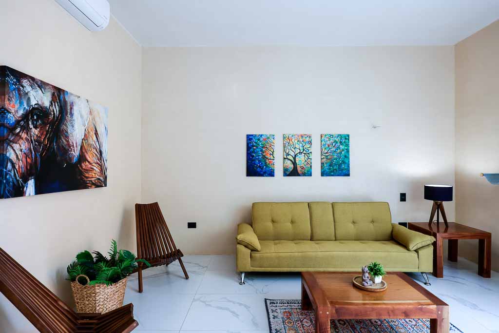 Modern living room with a yellow sofa and wooden furniture.