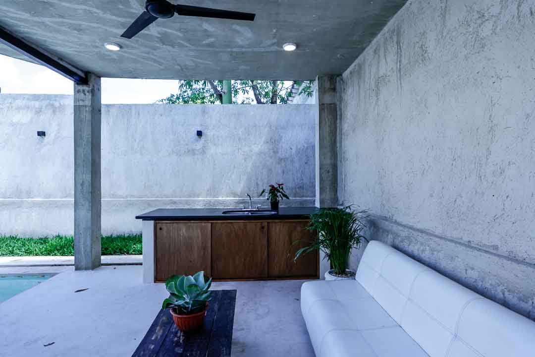 Minimalist living space with concrete walls and modern furniture.
