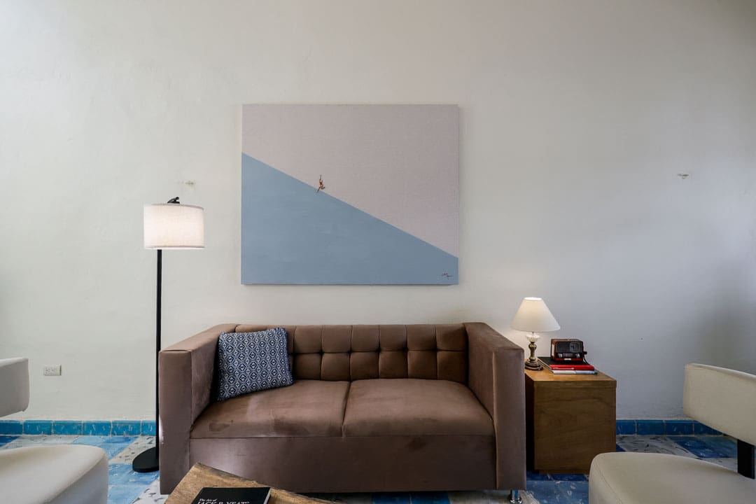 Cozy living room with brown sofa and minimalist artwork.