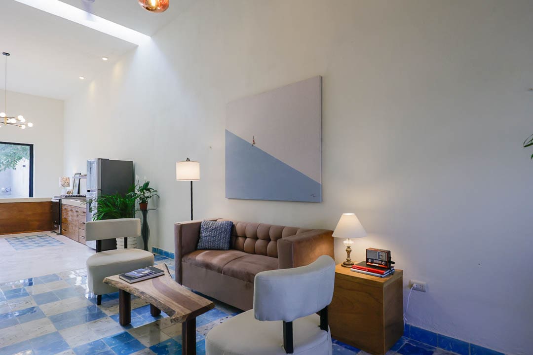 Cozy living room with modern art and warm lighting.