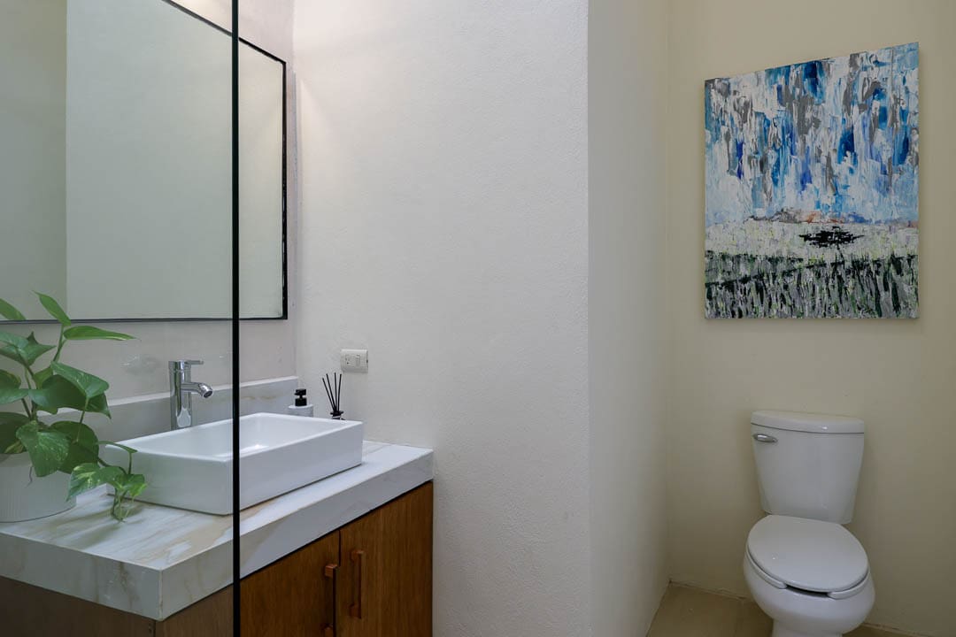 Modern bathroom with a vessel sink and large mirror.