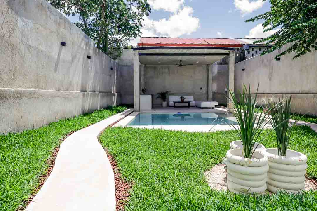 Modern backyard with a small pool and minimalist seating area.