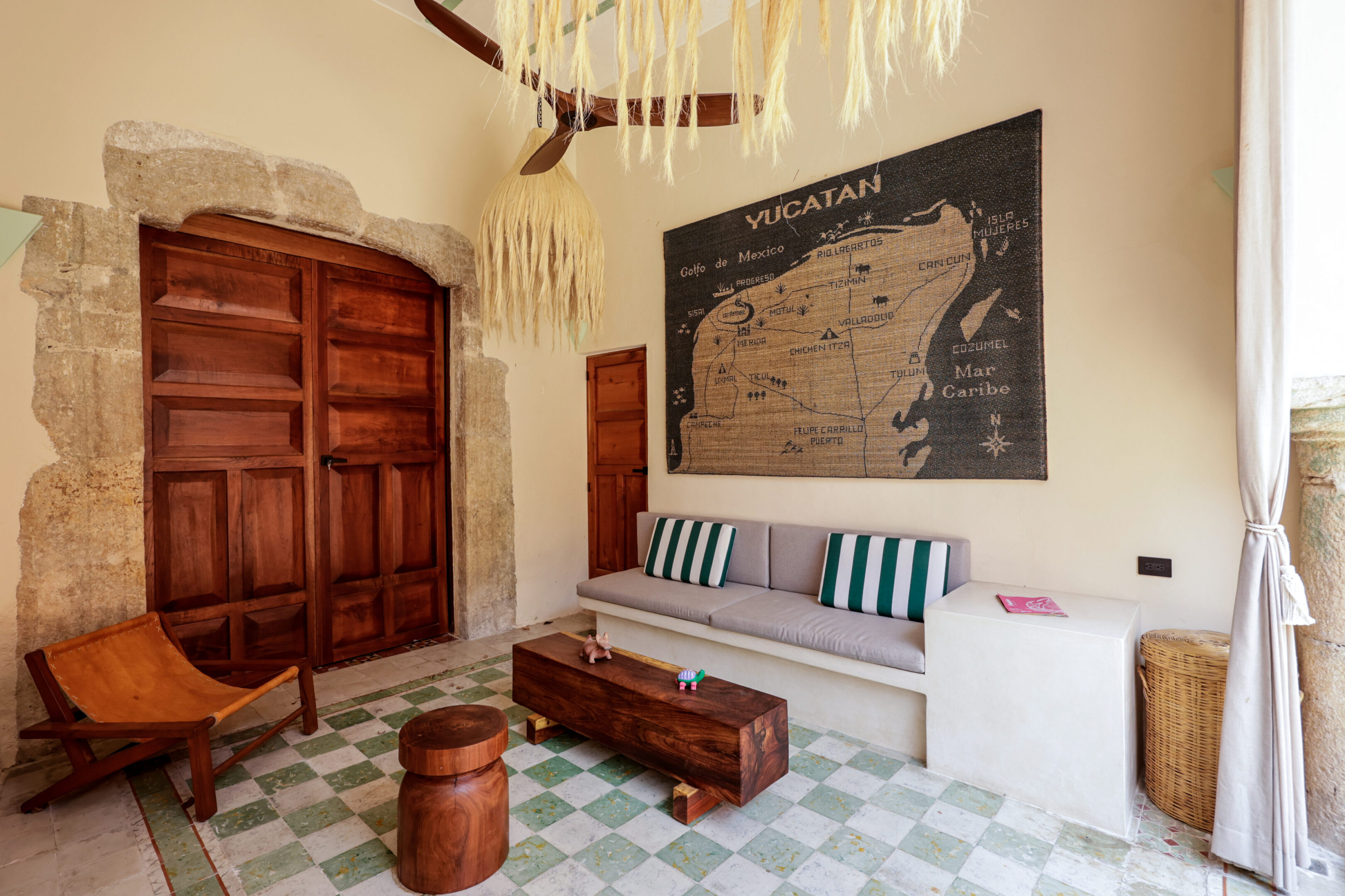 Cozy room with wooden furniture and a patterned wall tapestry.