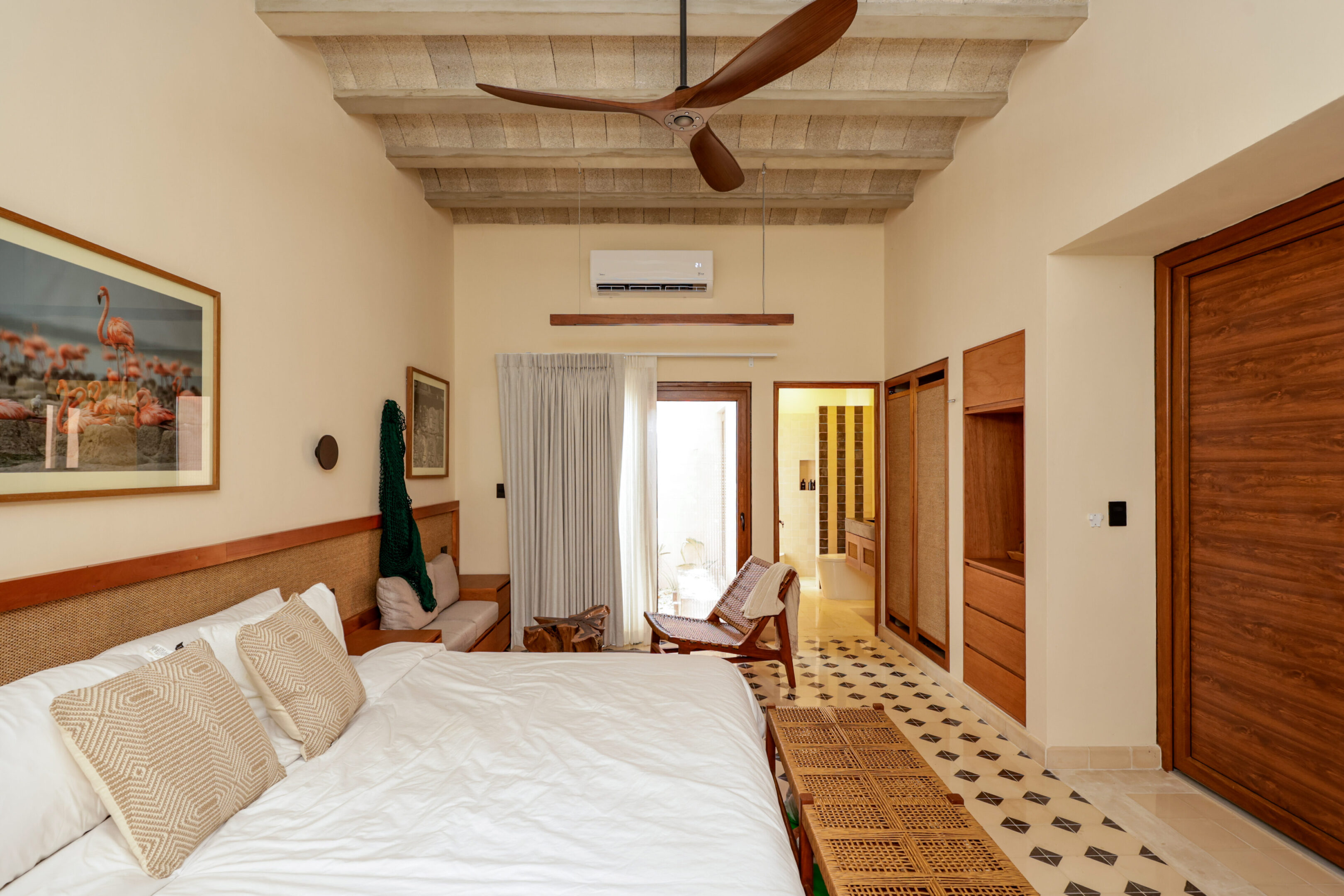 Cozy bedroom with a large bed and ceiling fan.