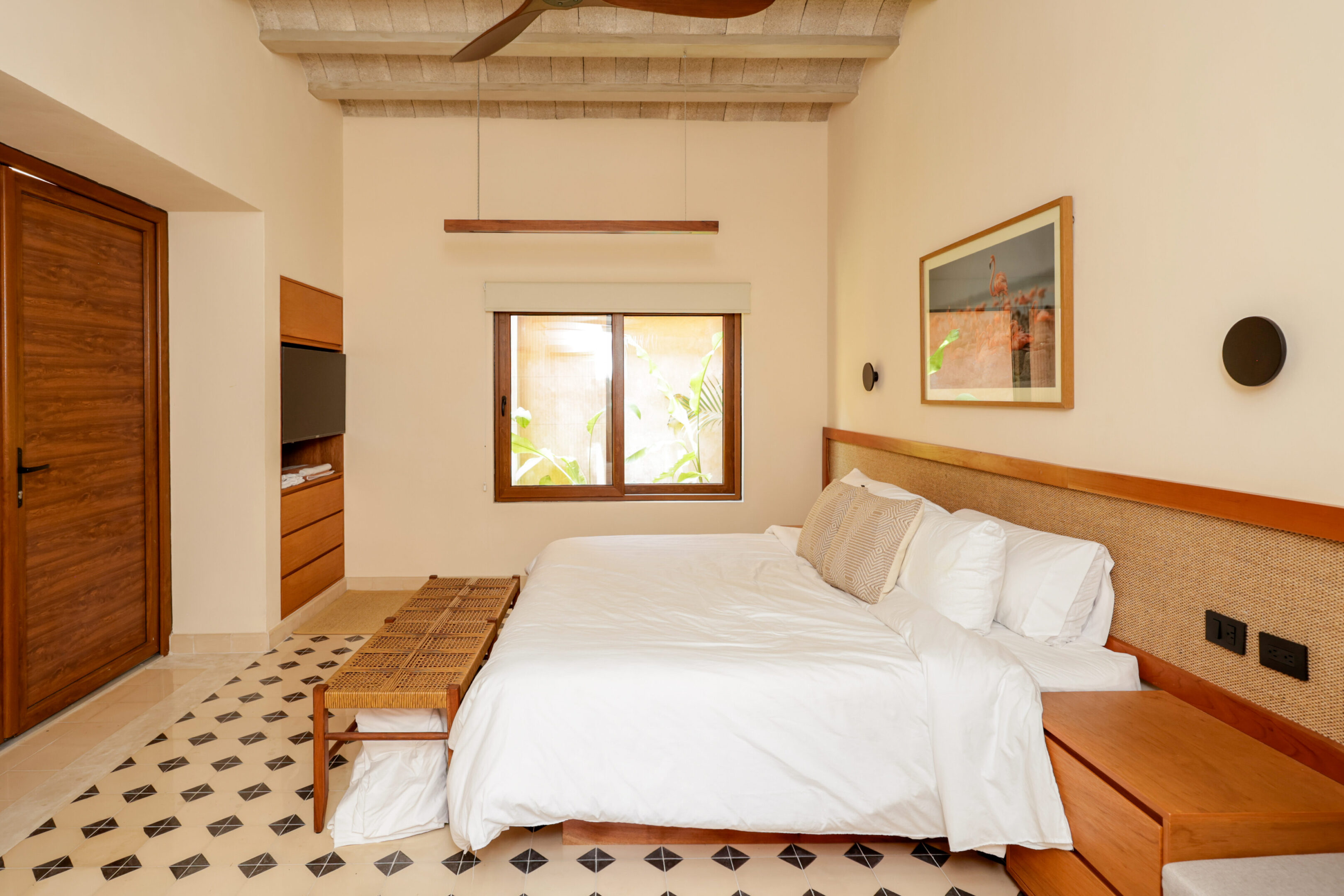 Bright, cozy bedroom with a large bed and warm decor.