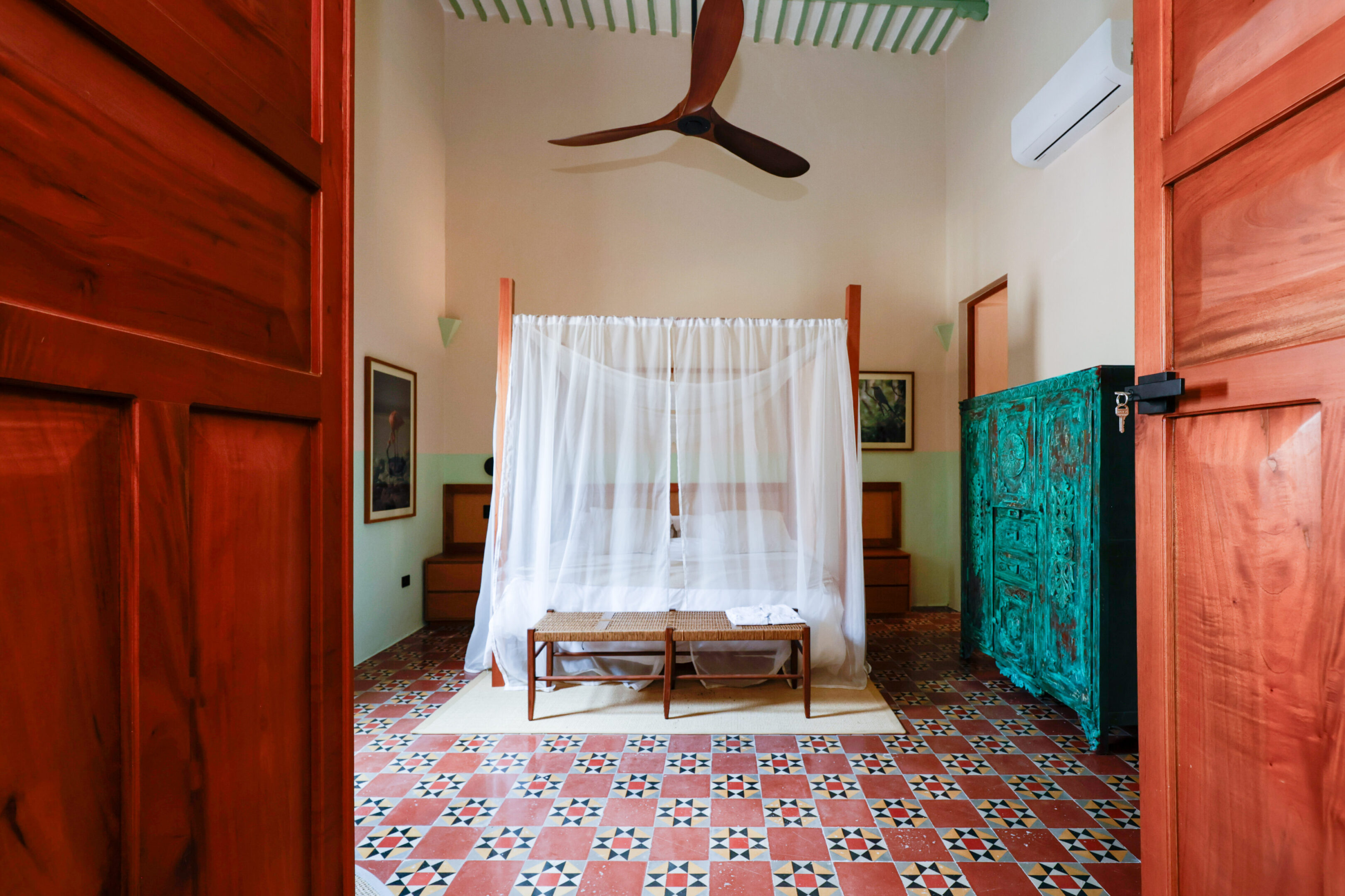 Cozy bedroom with mosquito net and vintage furniture.