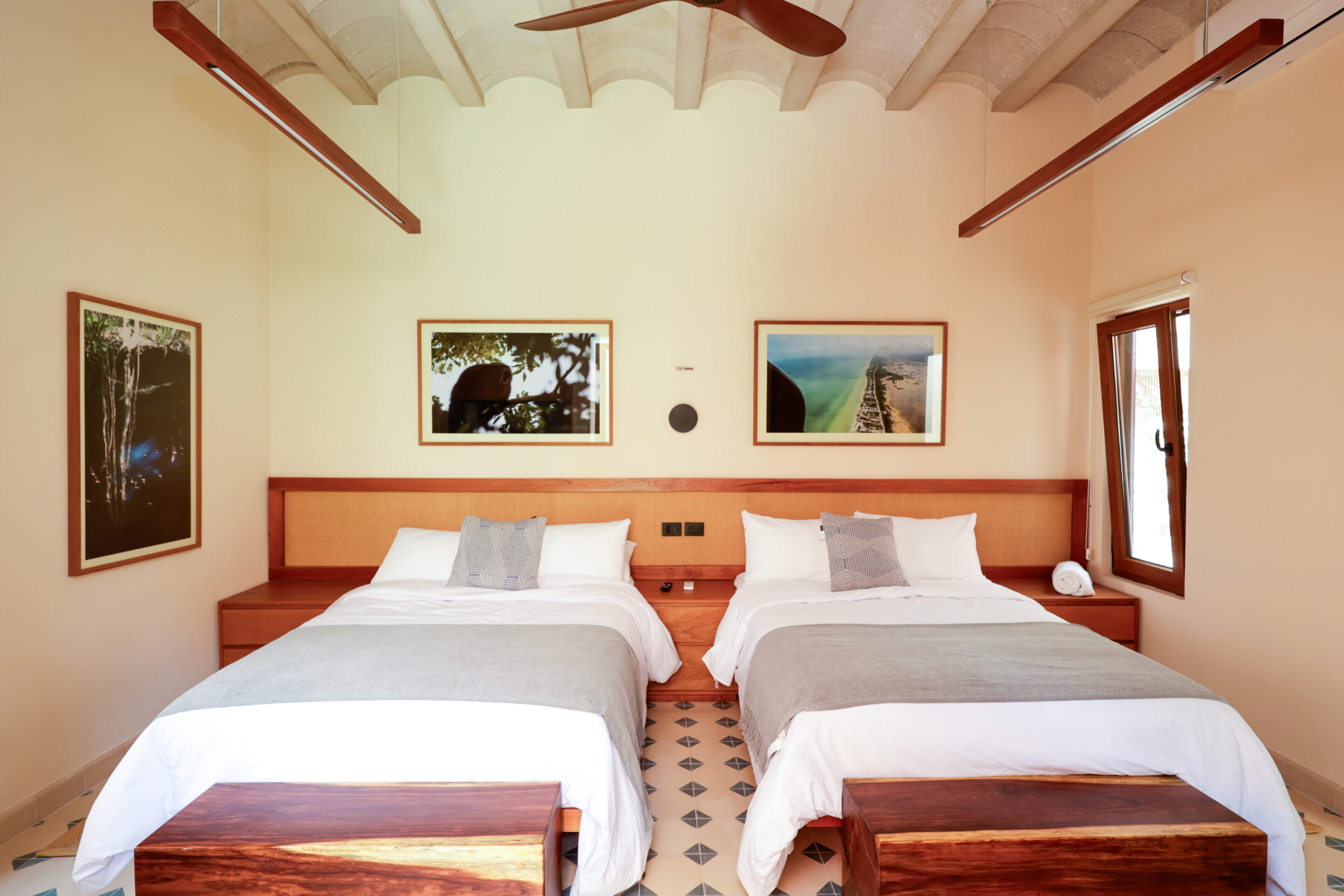 Cozy room with two single beds and wooden accents.