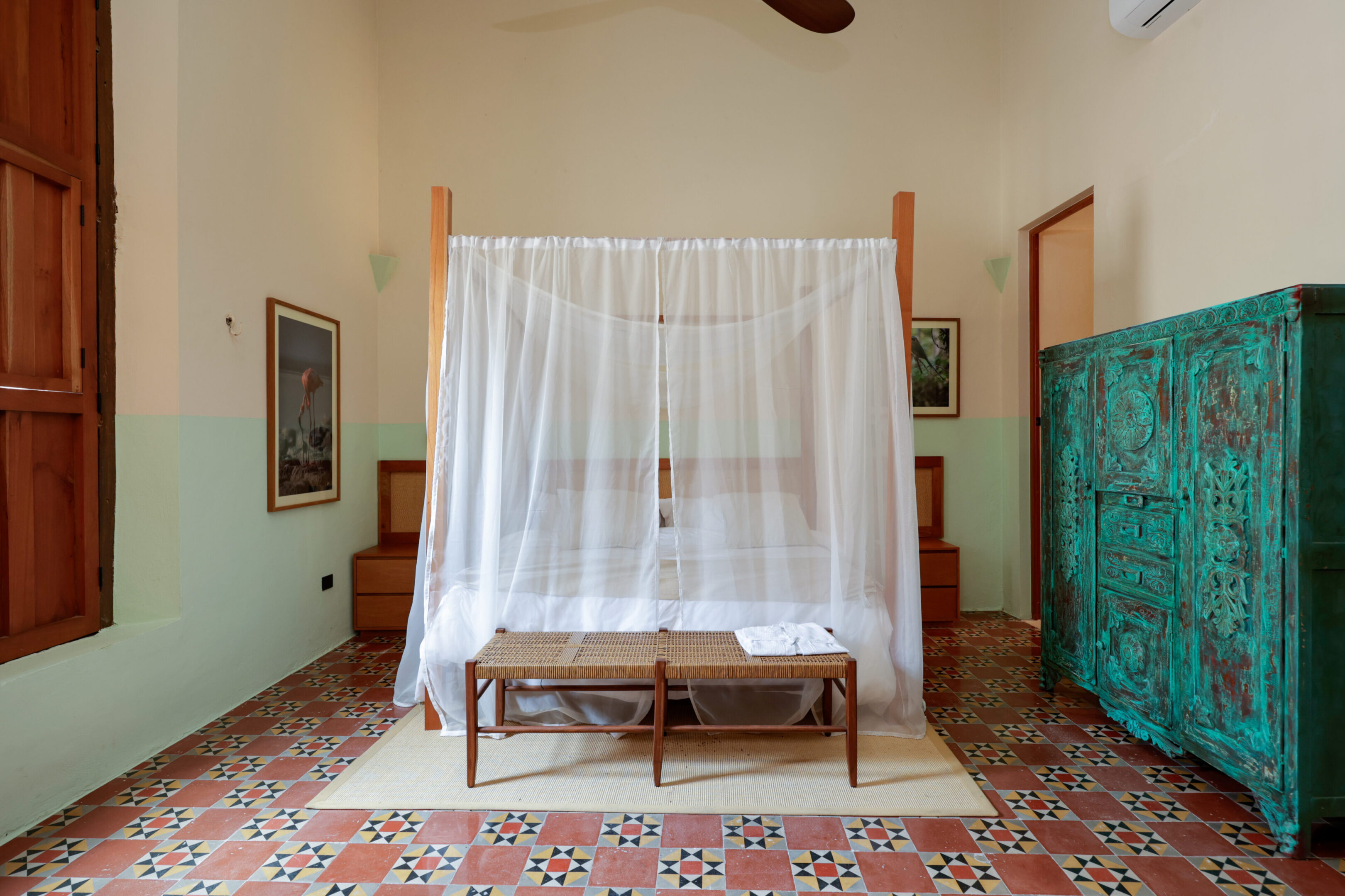 A vintage bedroom with a canopy bed and wooden furniture.