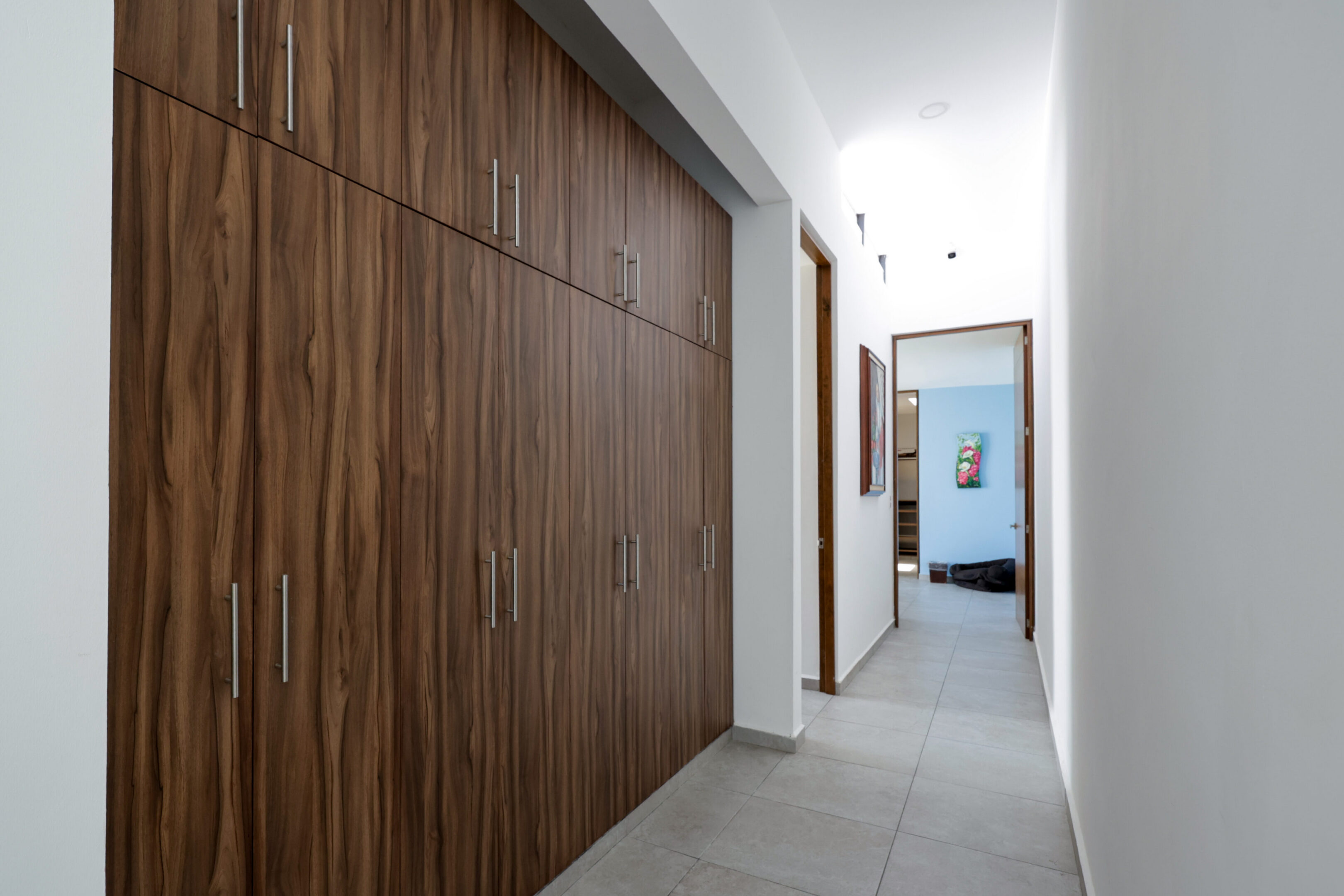 Minimalist hallway with wooden sliding doors and recessed lighting.