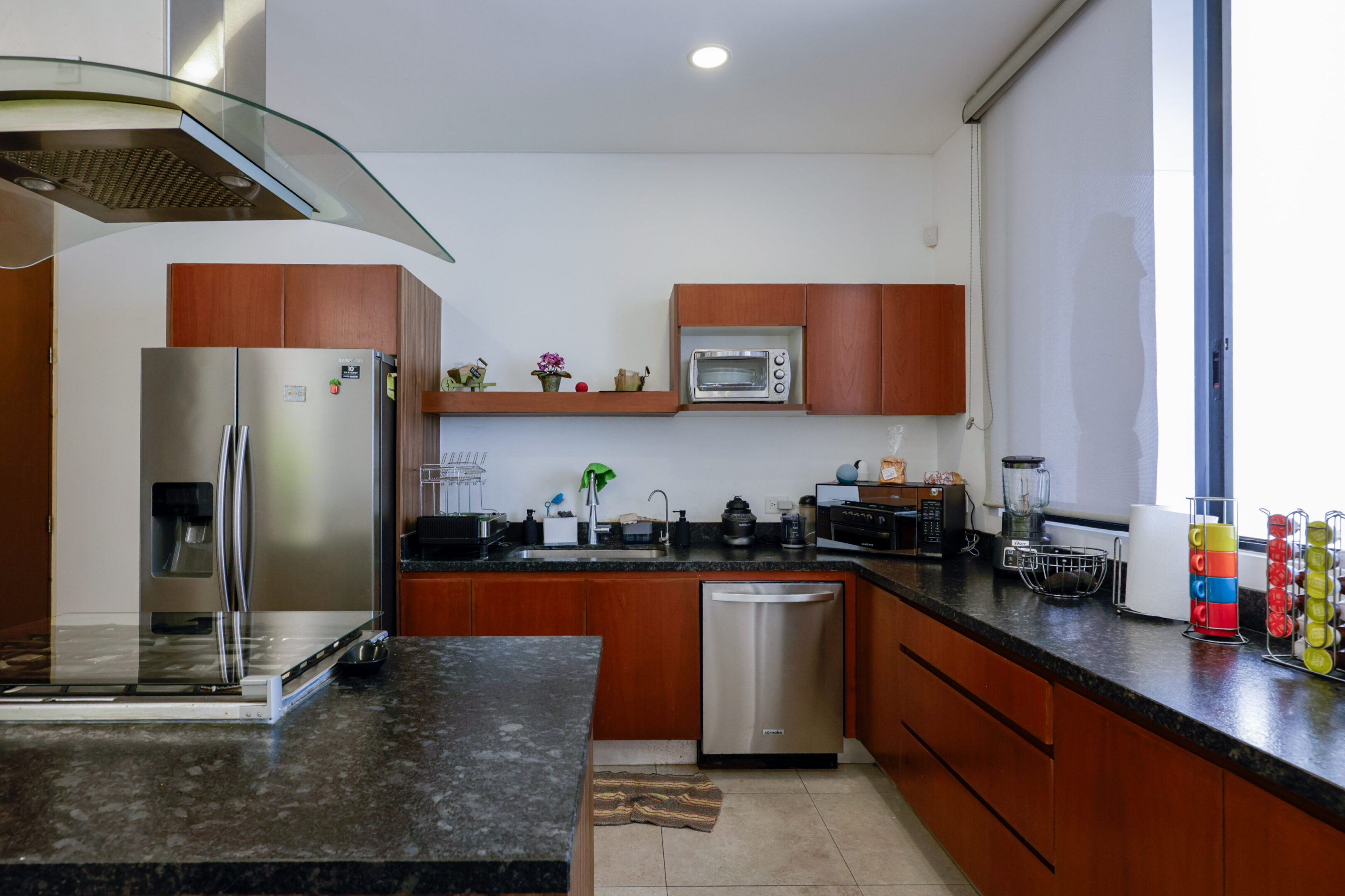 Modern kitchen with wooden cabinets and granite countertops.