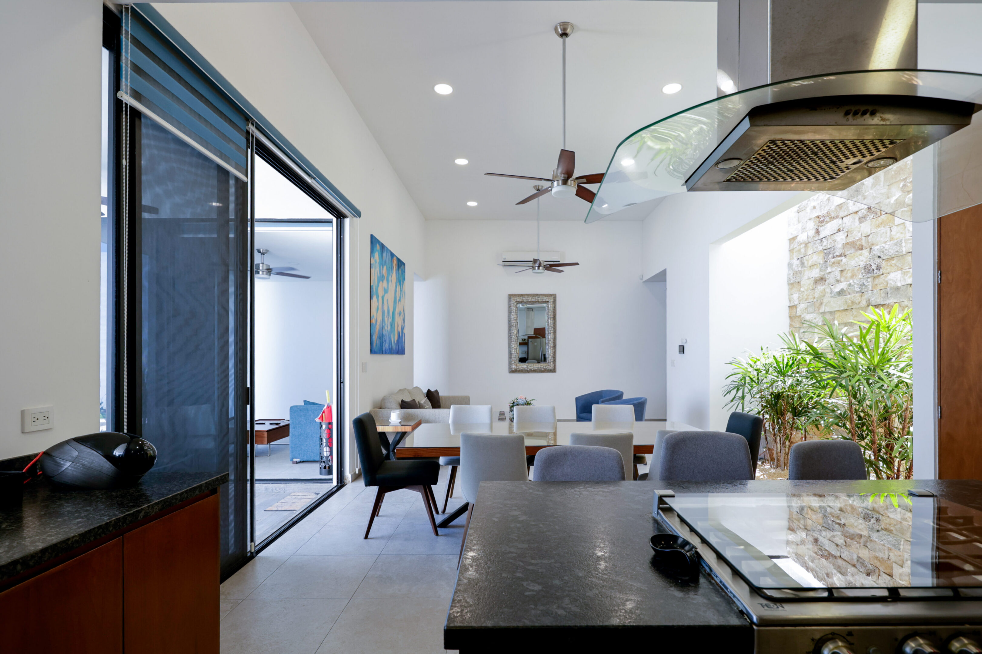 Modern kitchen with open dining area and outdoor access in a bright home.