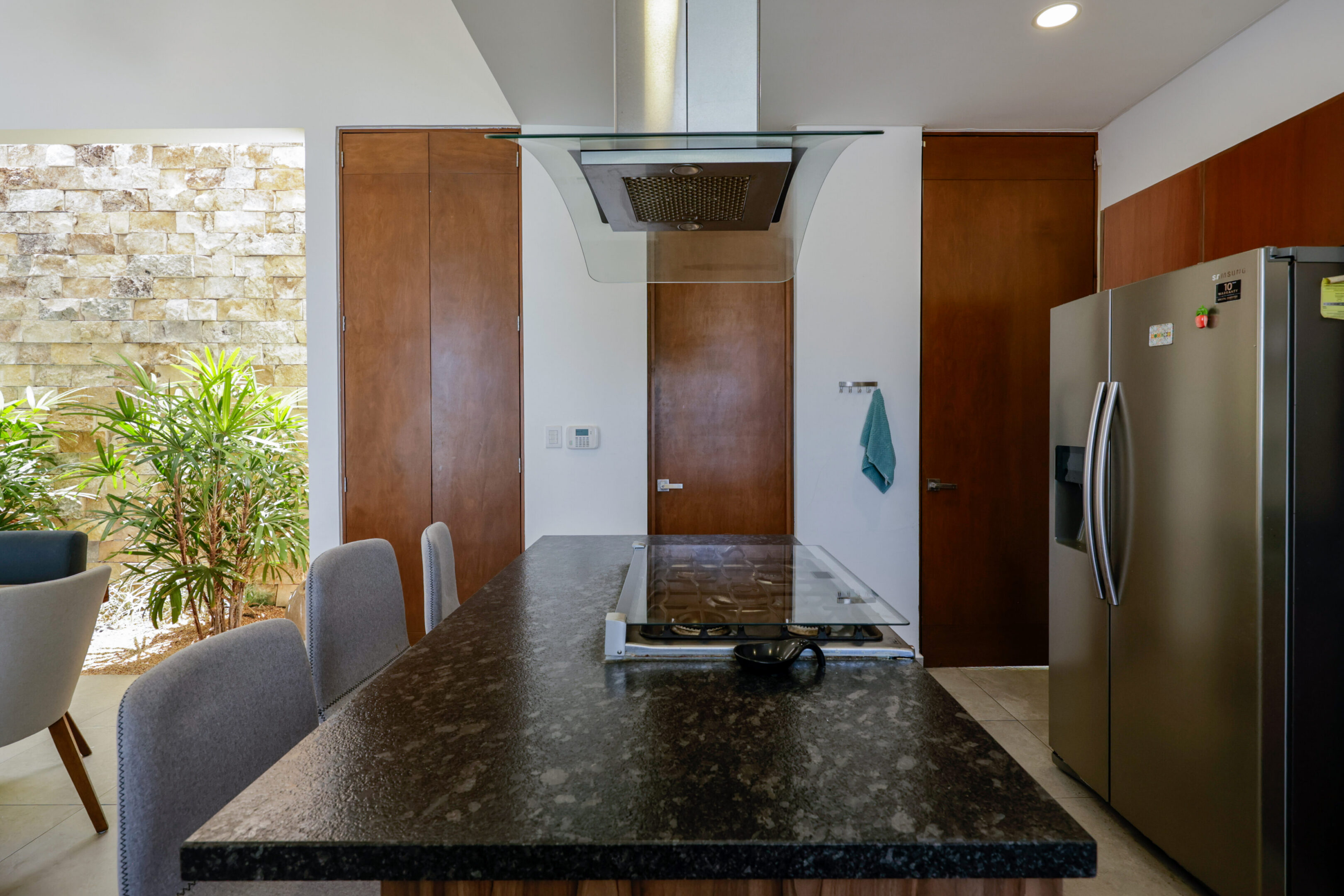 Modern kitchen island with granite countertop and built-in stove.