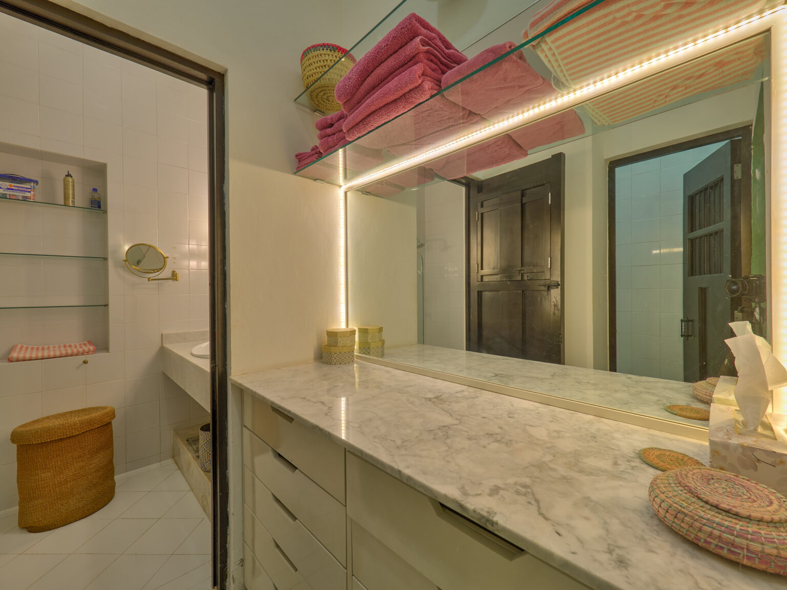 Marble bathroom vanity with pink towels