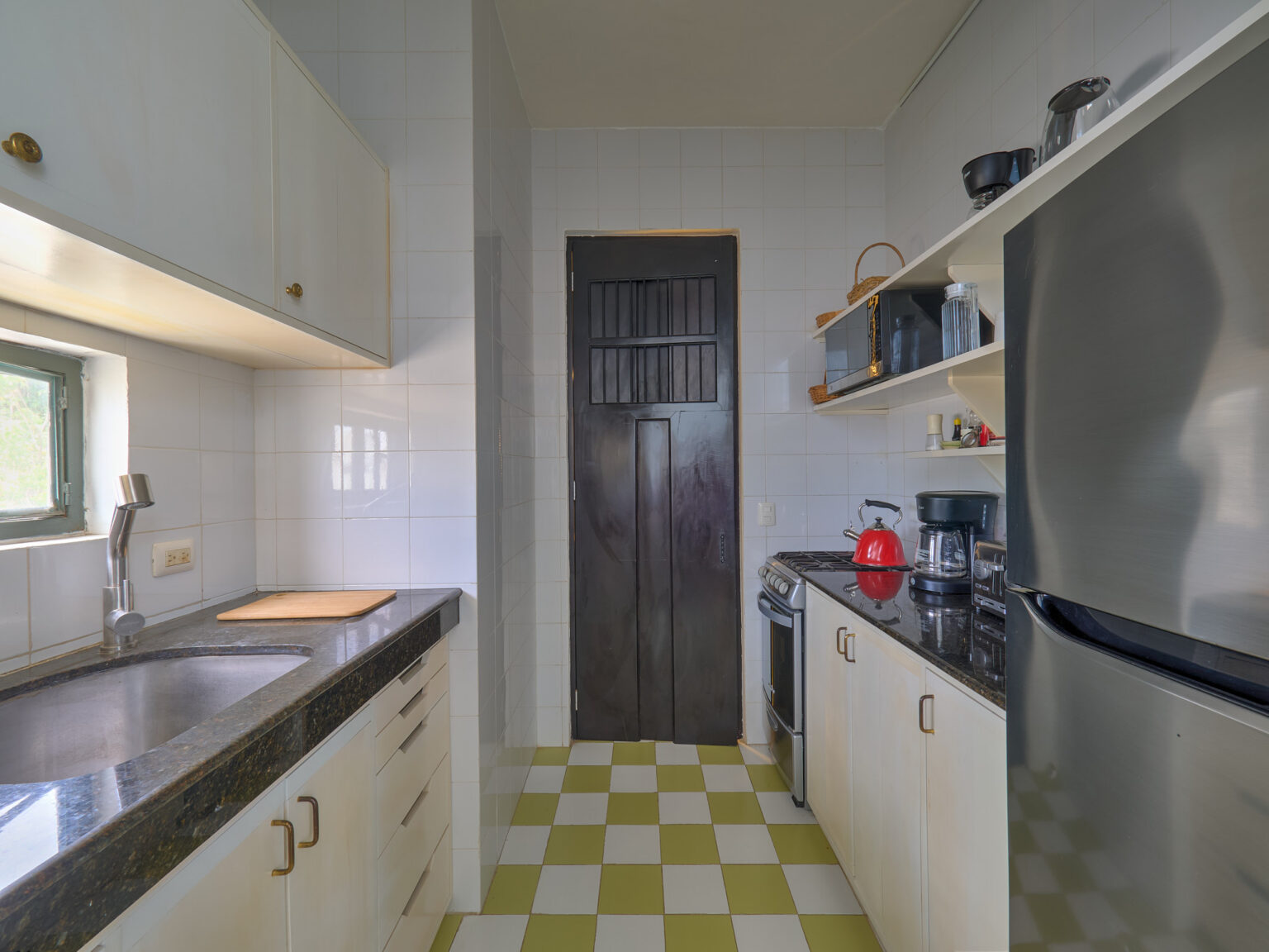 Narrow galley kitchen with checkered yellow floor