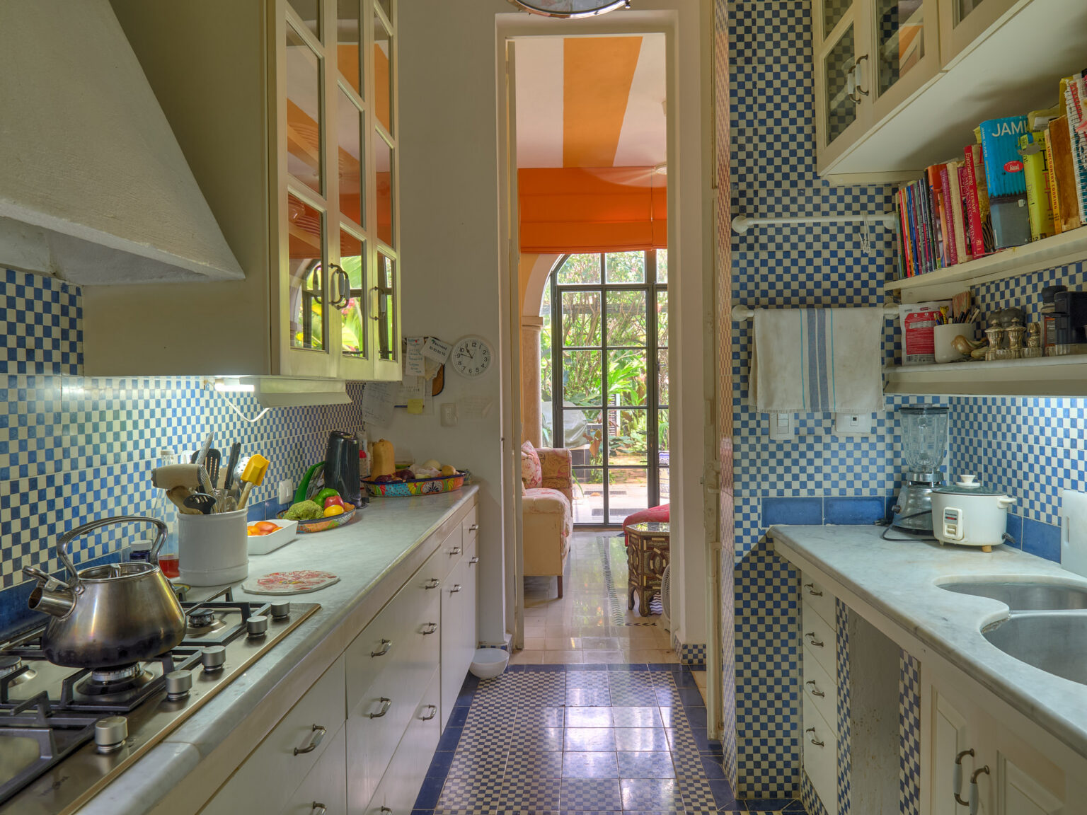 Bright galley kitchen with blue checkered tiles