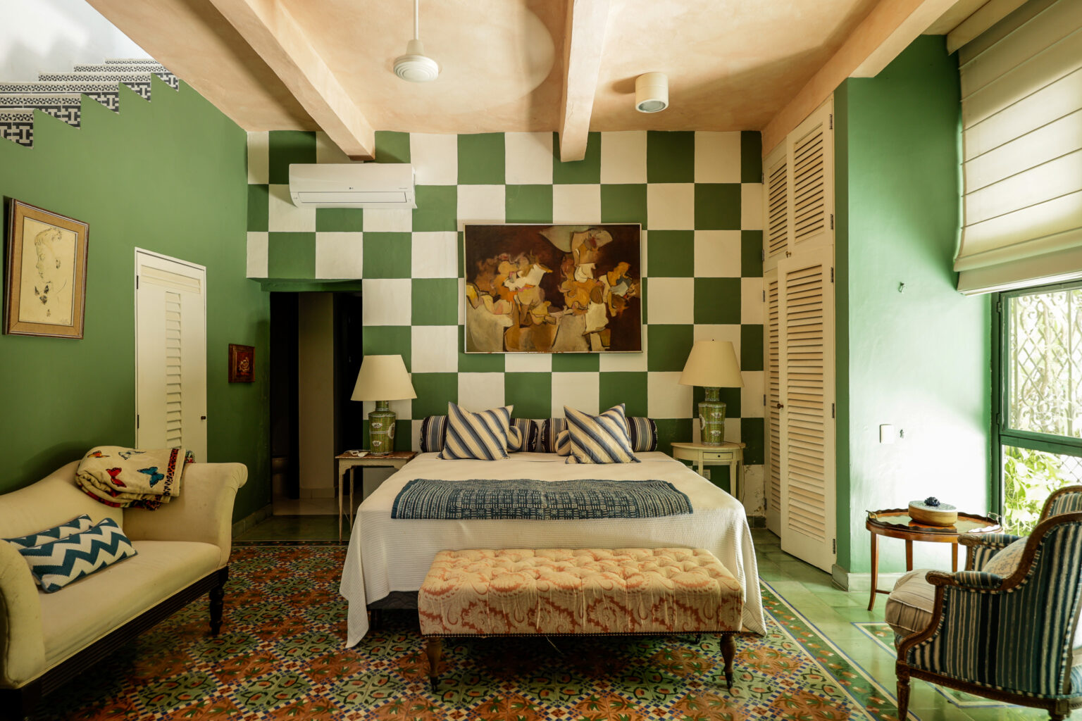 Bedroom with green checkerboard wall and bed