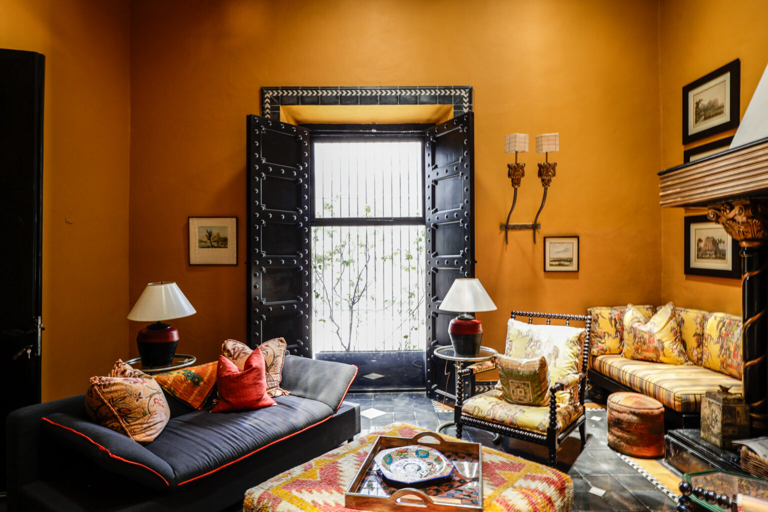 Warm eclectic living room with patterned sofas