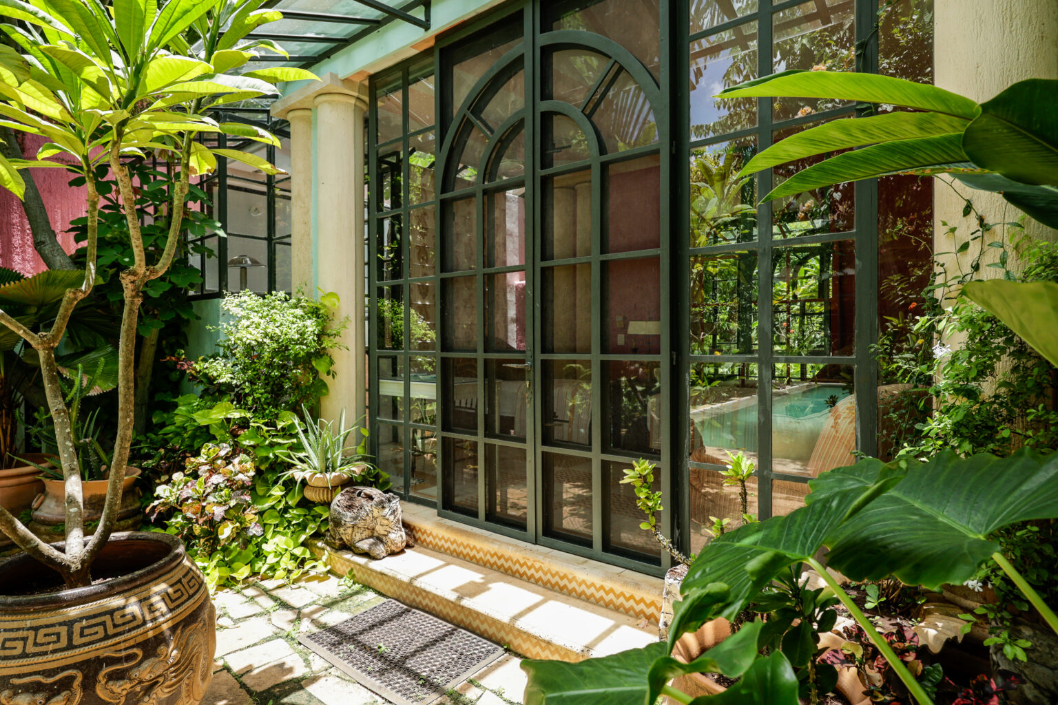 Sunlit courtyard with arched glass doors