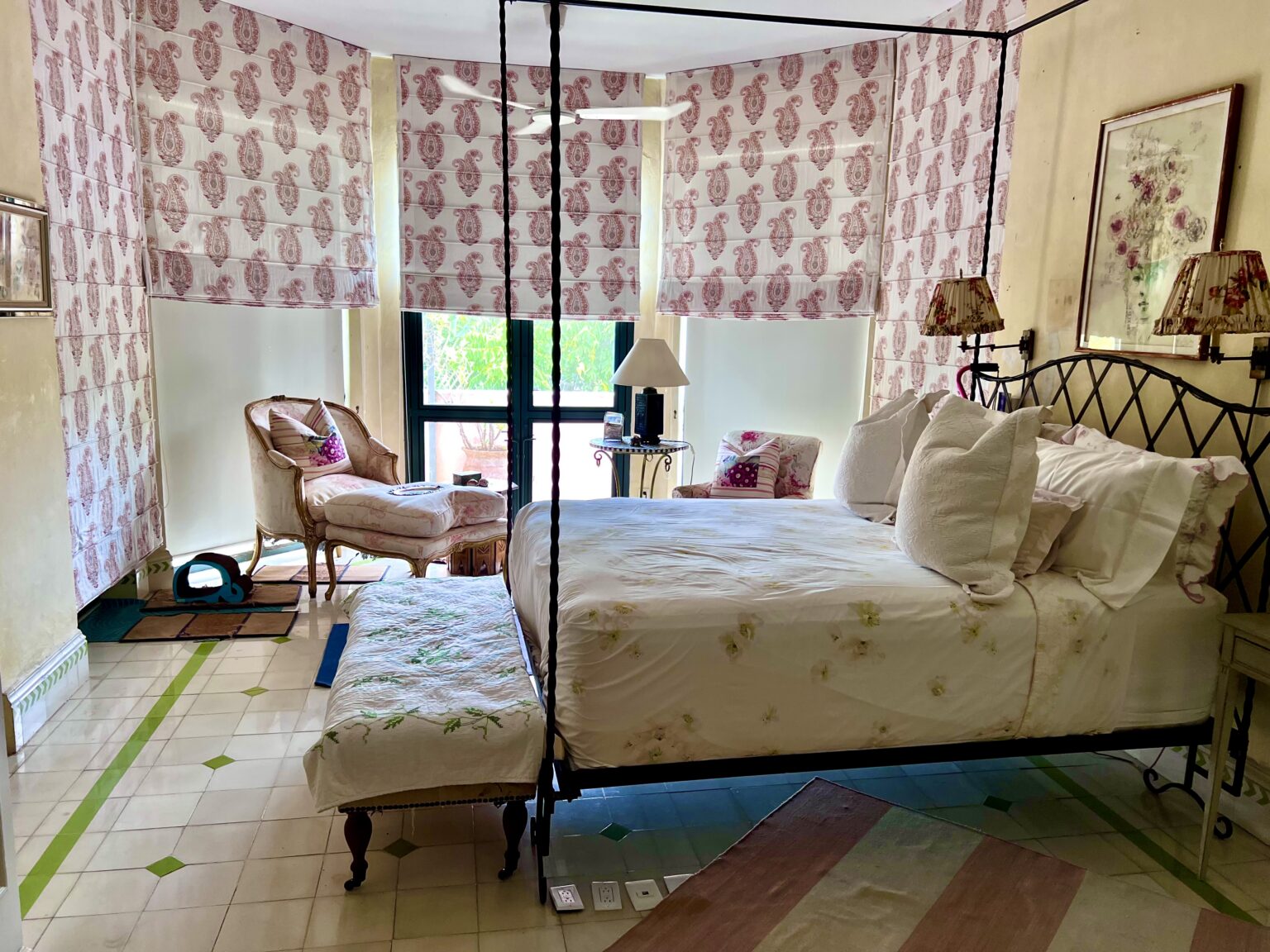 Four-poster bed in floral-patterned bedroom