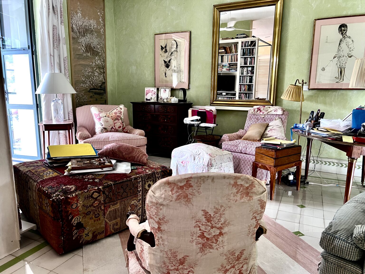Cozy living room with patterned armchairs and ottoman
