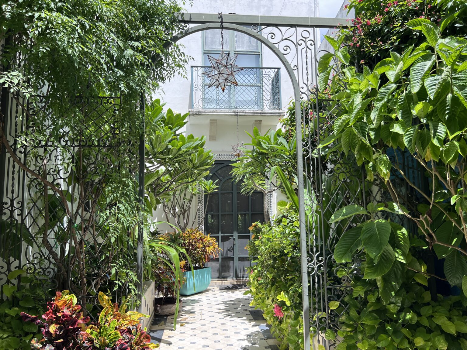 Wrought-iron garden archway leading to house